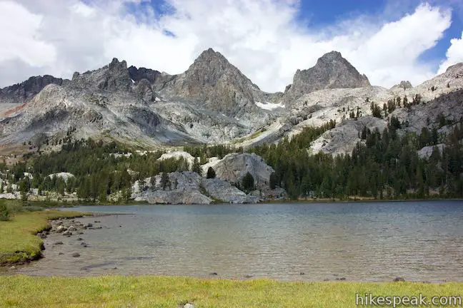 This hike of 14 miles or more crosses a scenic stretch of the Sierra through pine forests, lakes, meadows, and streams to reach a stunning backcountry lake below Mount Ritter and Banner Peak.